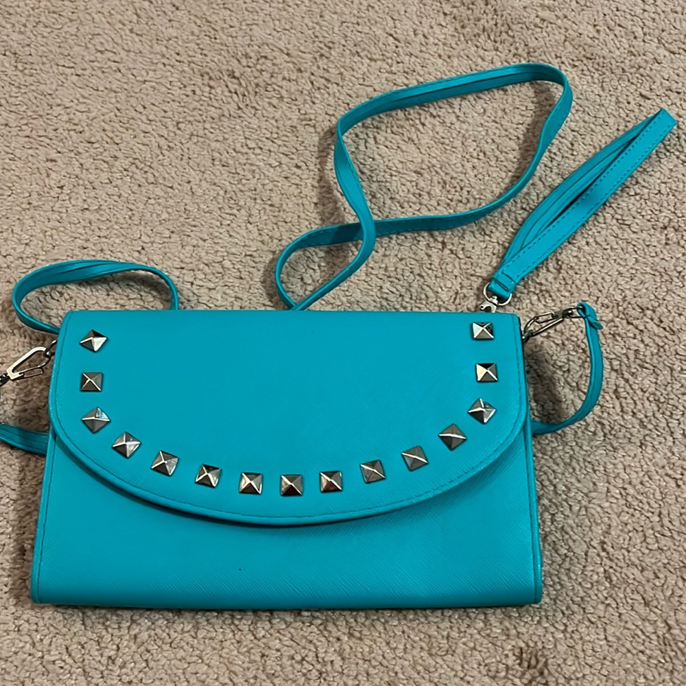 Blue studded women’s clutch with wrist and shoulder strap